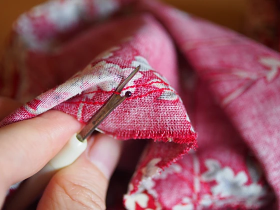 Unpicking a thread with a seam ripper